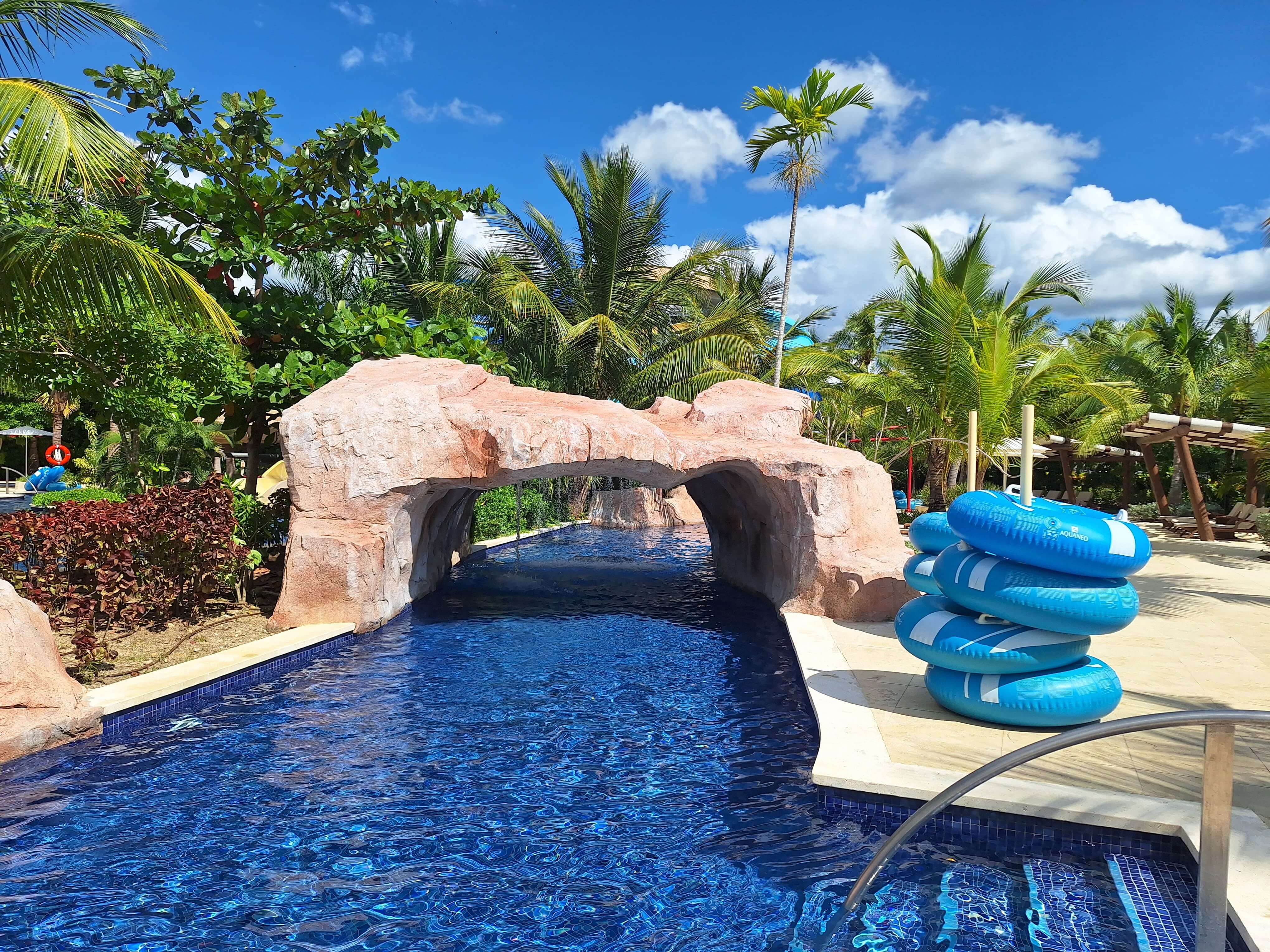 The lazy river winds around the water park, featuring small waterfalls.